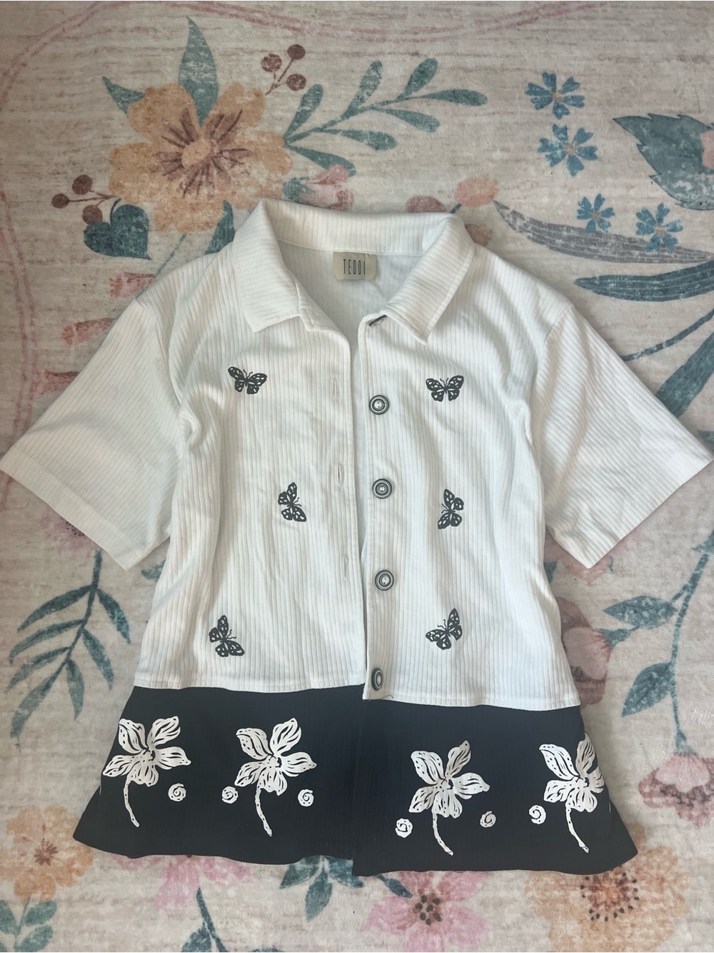 Teddi White Button-Front Top with Black Floral Hem and Butterfly Accents